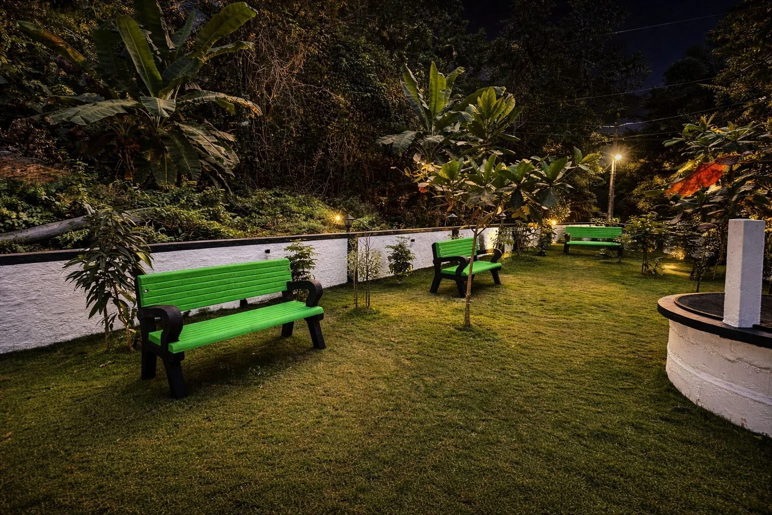Spacious landscaped lawn and seating at night