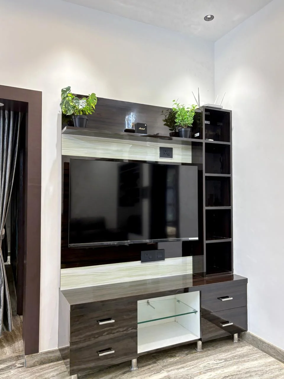 Television and entertainment unit at AMB Guest House